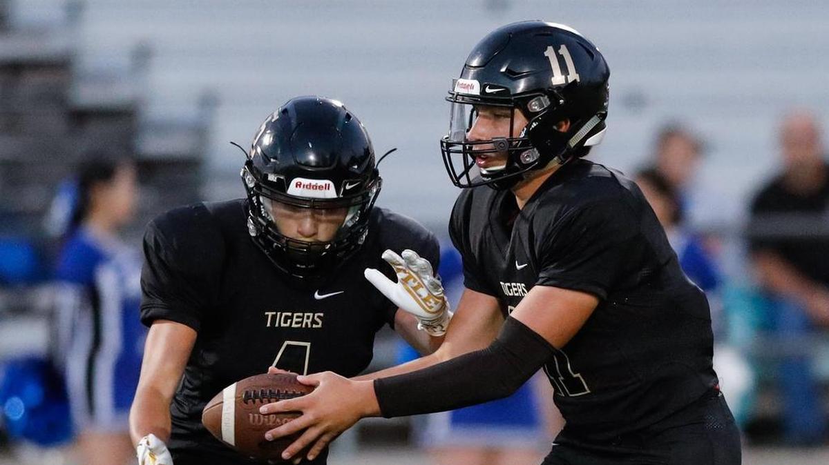 San Luis Obispo High School quarterback Emilio Corona hands off to Anthony Arroyo in a nonconference game Friday, September 21, 2018, against Hanford West.