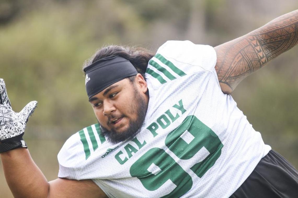 Cal Poly senior defensive linemen Augustino Elisaia runs through drills during fall camp.