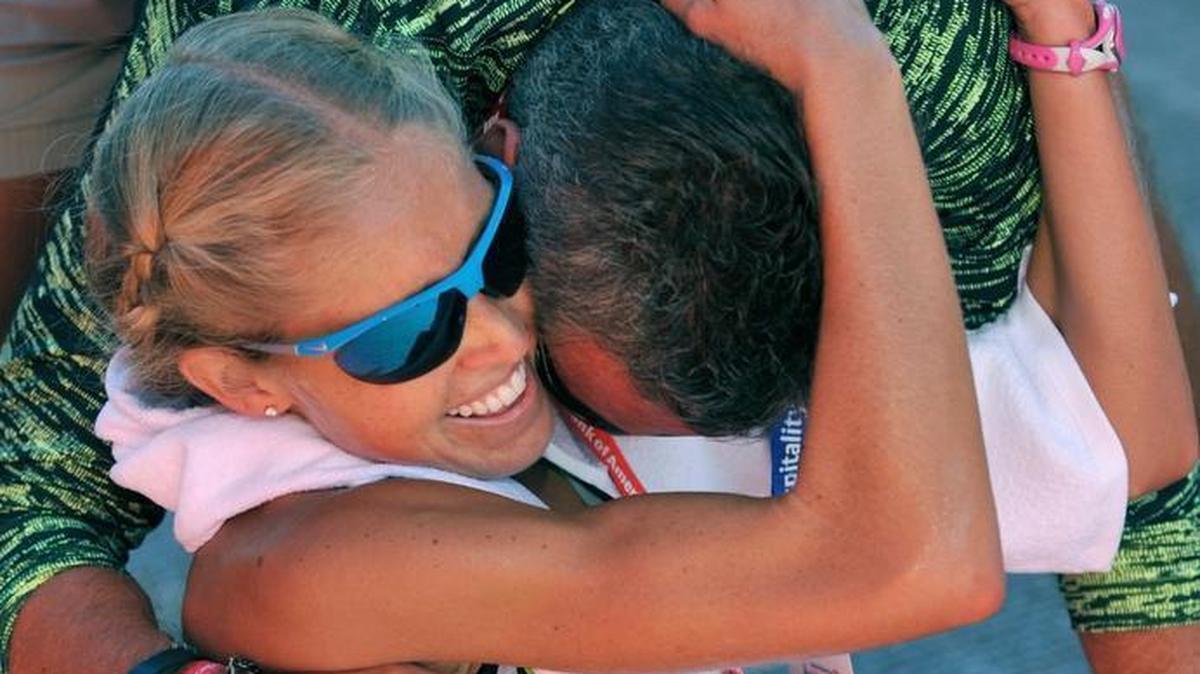 Jordan Hasay of the United States celebrates with her father, Joe Hasay, after finishing in third place in the Chicago Marathon on Sunday.
