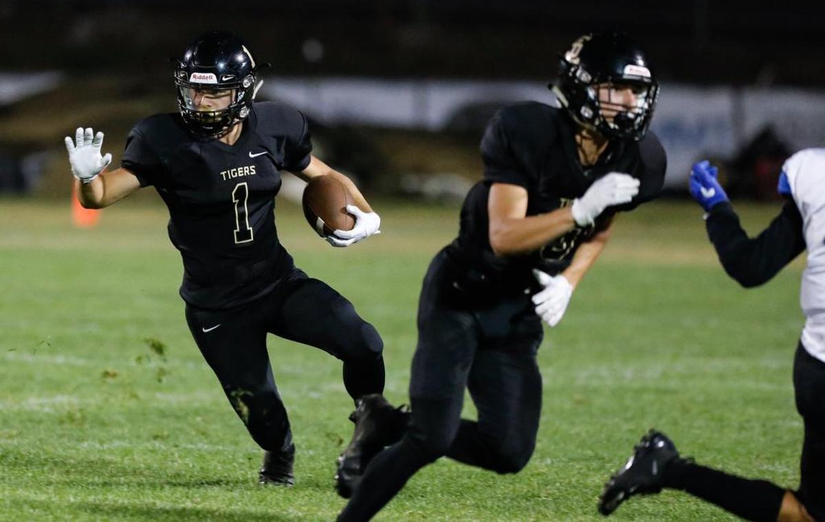 San Luis Obispo High School running back Jeremy Fitzsimmons carries the ball in a non-conference game Friday night against Hanford West.