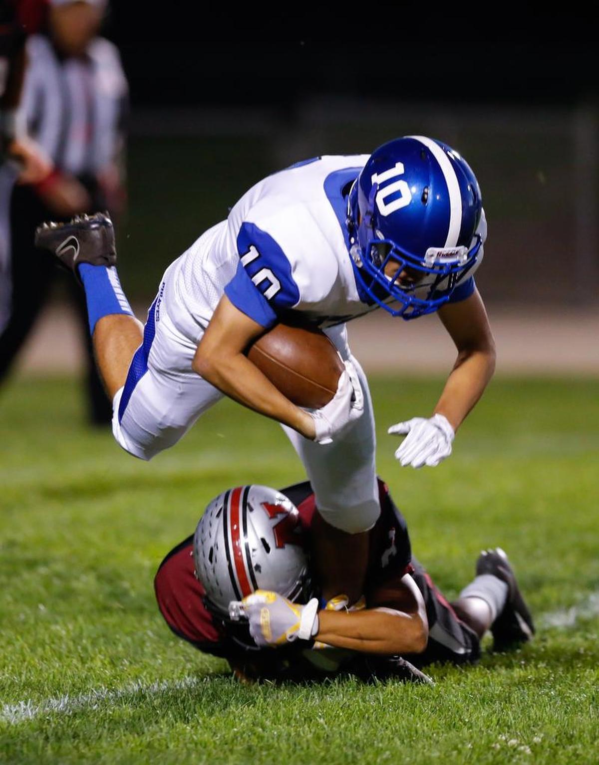 Morro Bay High School’s Juan Garcia is pulled down by a Niomo defender in an Ocean League football game Friday night.