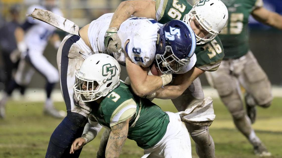 Cal Poly hosts San Diego in the first round of Football Championship Subdivision playoffs at Alex G. Spanos Stadium in San Luis Obispo, CA, on Saturday, November 26, 2016. Cal Poly's Joseph Gigantino (36) tackles San Diego's Ross Dwelley (85) assisted by Cal Poly's Kevin Griffin (3) .